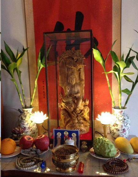 Wood carving of Avalokitesvara Bodhisattva offered at home